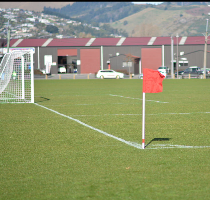 White football corner pole with red flag