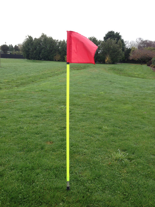 Yellow corner flag pole with red flag