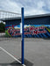 Volleyball post with volleyball net, outdoors, in-ground semi-permanent.